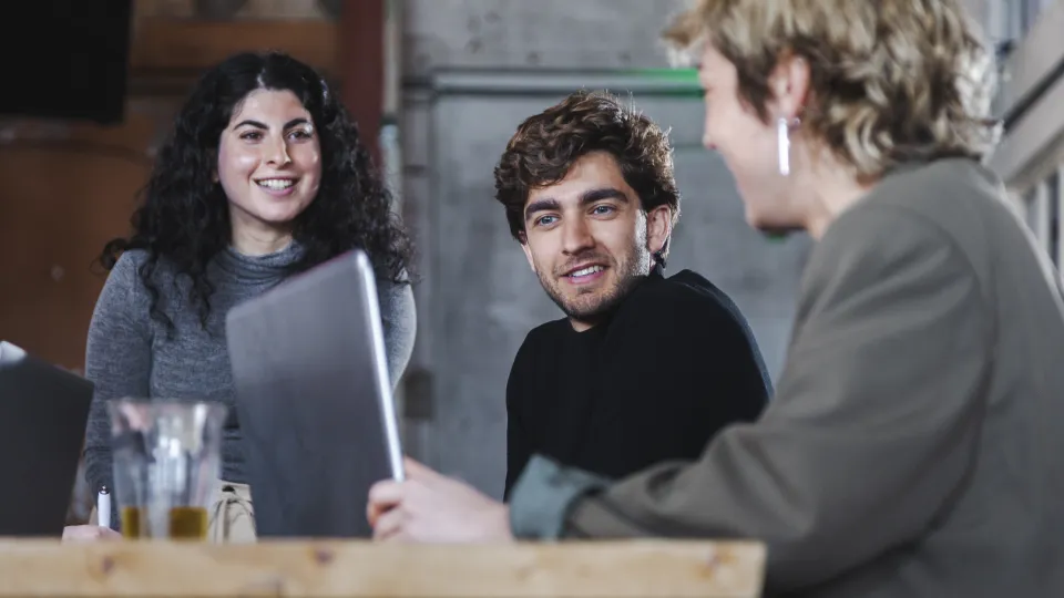 Mensen aan een tafel de ideeën uitwisselen